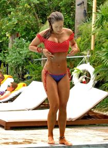 Jennifer Nicole Lee showing off her fit bikini body on a bea