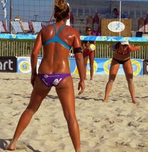 Tempting athletic girls playing beach volleyball