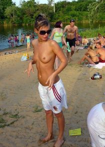 Young teenager naturist posing at public, she takes off her panties on the beach in the