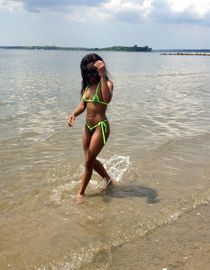 Little curvy ebony Aniya in a bikini posing on the sea beach