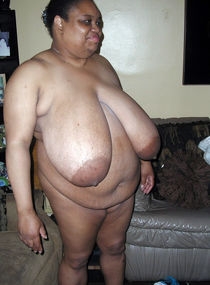 Very fat black mature woman sitting naked at home