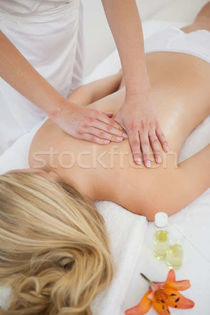 Blonde enjoying a back massage stock photo Â© Wavebreak Media