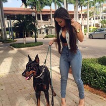 Hot chick and her dog enjoy in wallking to the park